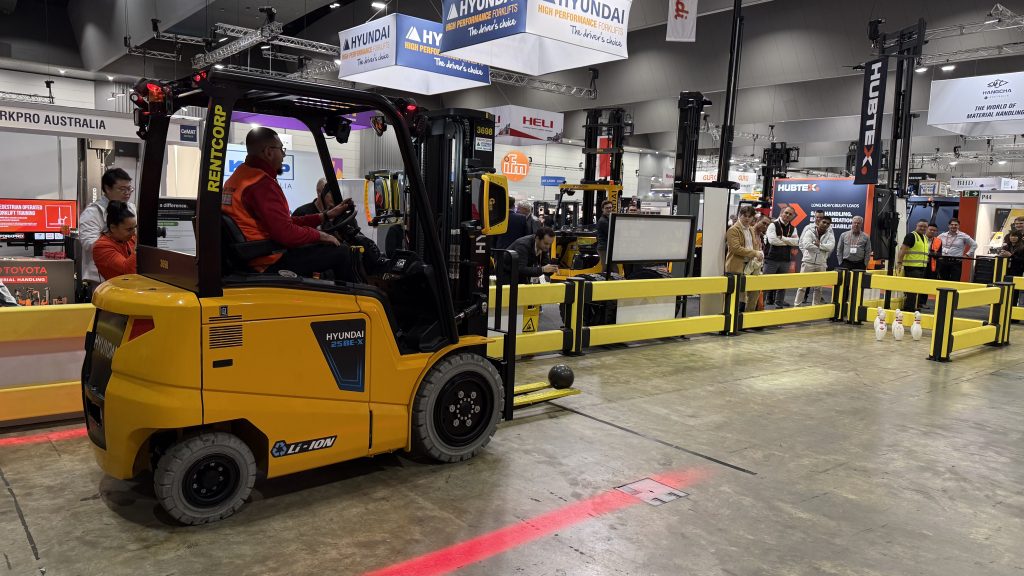 Hyundai 25BE-X forklift rolling a bowling ball toward pins at the Australian Forklift Championship 2026, CeMAT Melbourne.