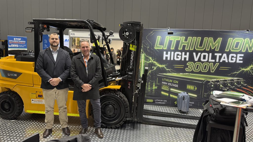 Hyundai Material Handling team beside a high-voltage lithium-ion forklift at CeMAT 2026.