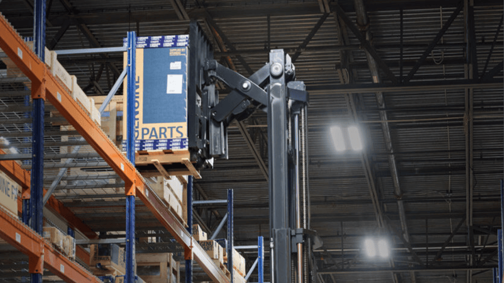 a pantograph reach mechanism extending into warehouse racking